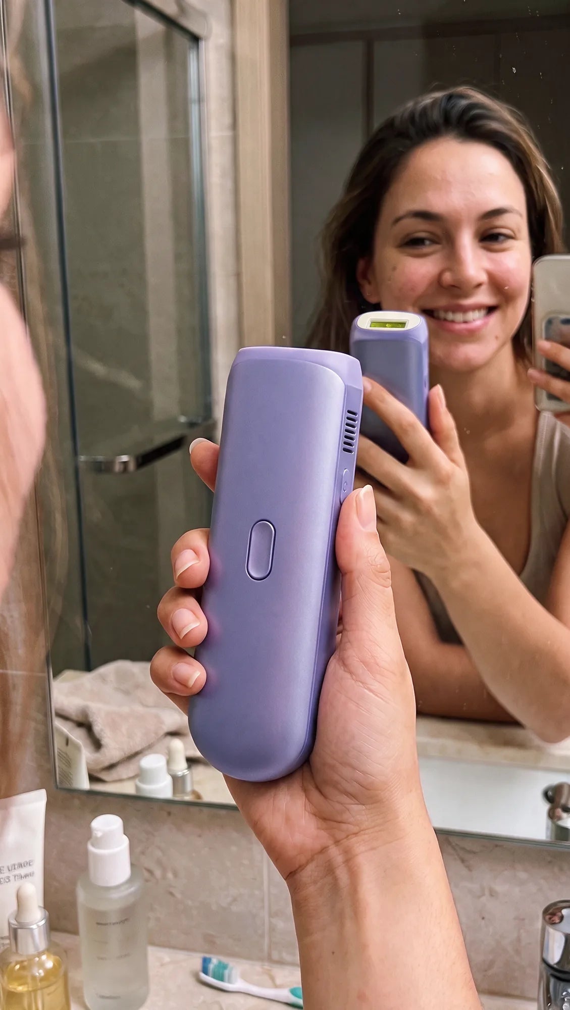 Casual bathroom mirror selfie of a woman holding a Zephra device