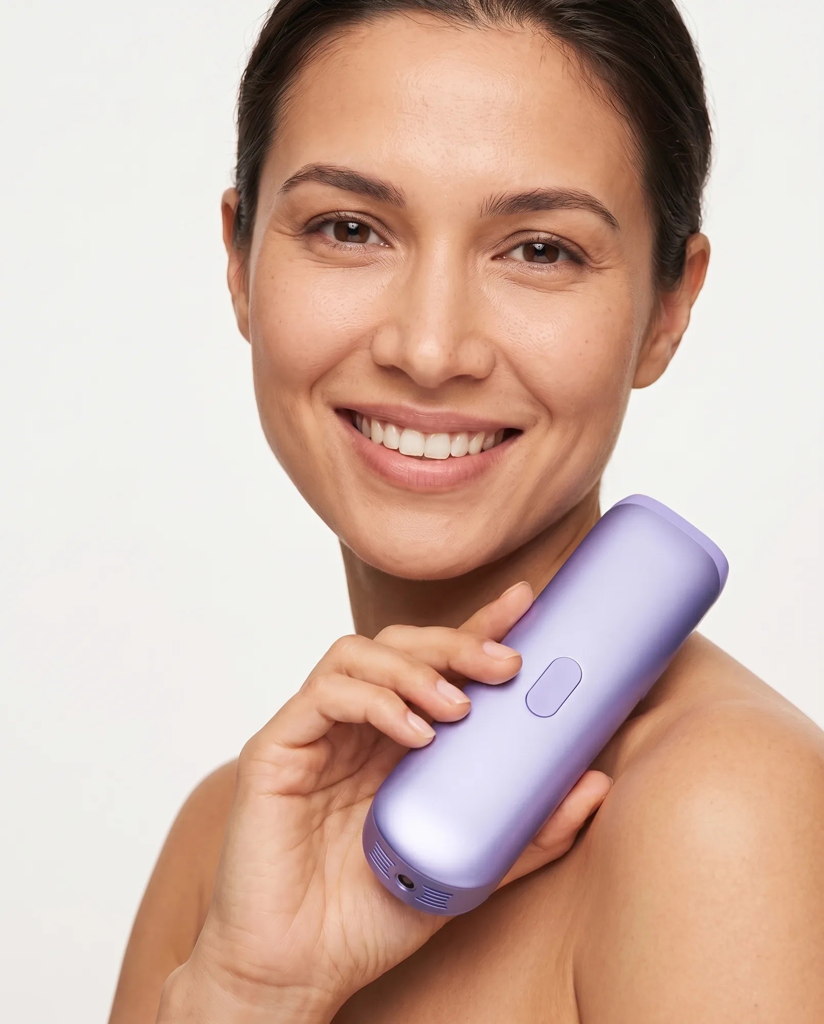 Smiling woman holding the Zephra handheld IPL hair removal device, matte lavender-purple body, studio product shot
